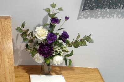 Purple and white flowers on a desk